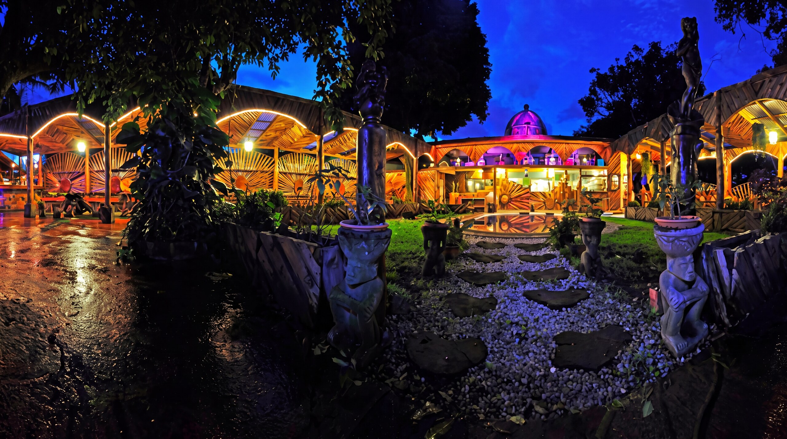 Hotel Casa Antigua at twilight — lantern-lit Spanish colonial courtyard and gardens