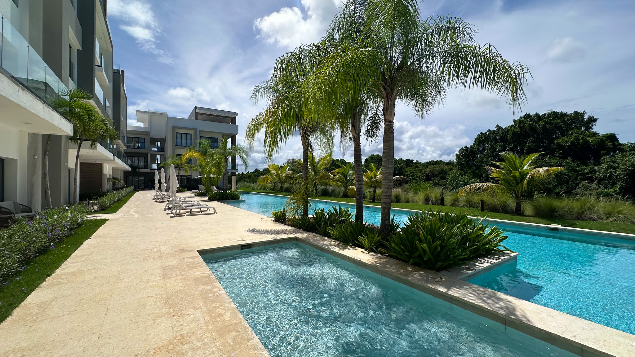 Cana Cove pool framed by palms and tropical gardens at Cana Bay